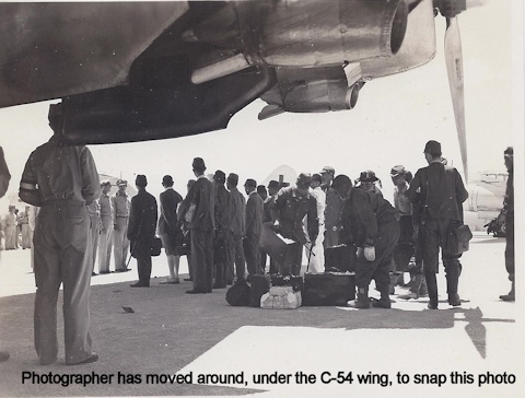 Japaese Surrender Party under the wing of a C-54 Skymaster